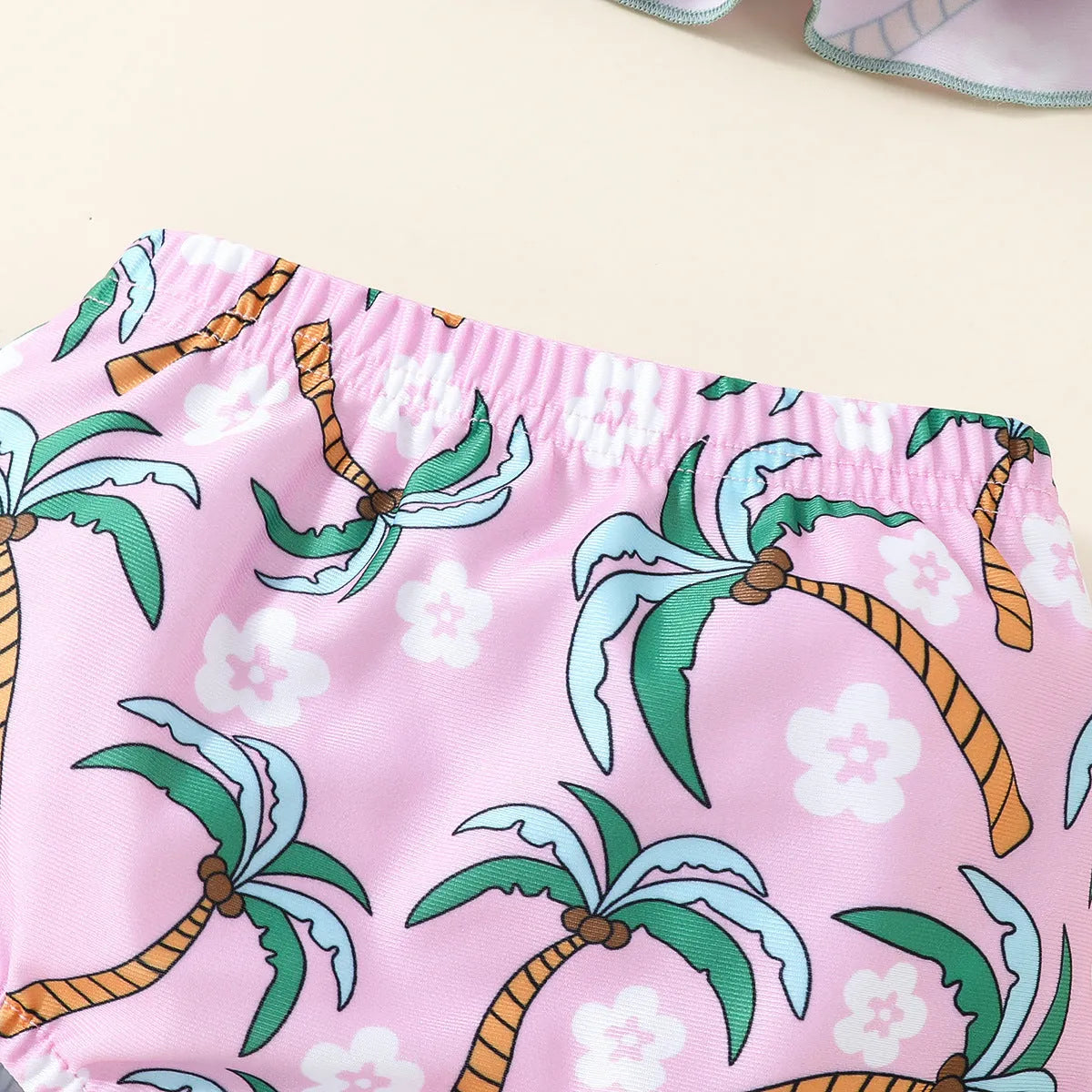 White baby swimsuit set with top and shorts on hanger