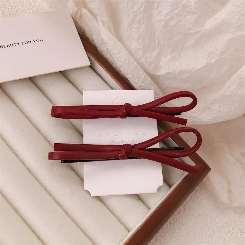 Wine red leather bow barrette hair clip with adjustable metal grip mechanism