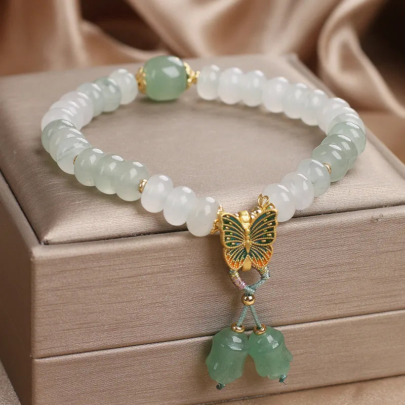 Green abacus bead bracelet for women with a butterfly tassel, pearls, and rhinestones