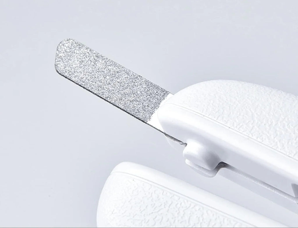 White LED pet nail clippers with transparent guard open, showing triangular steel blades and a nail file.