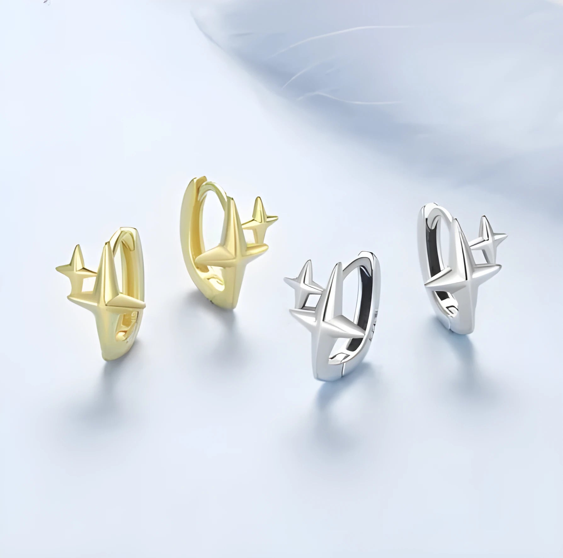 Minimalist star-shaped silver ear clips with oxidation finish and contemporary design details