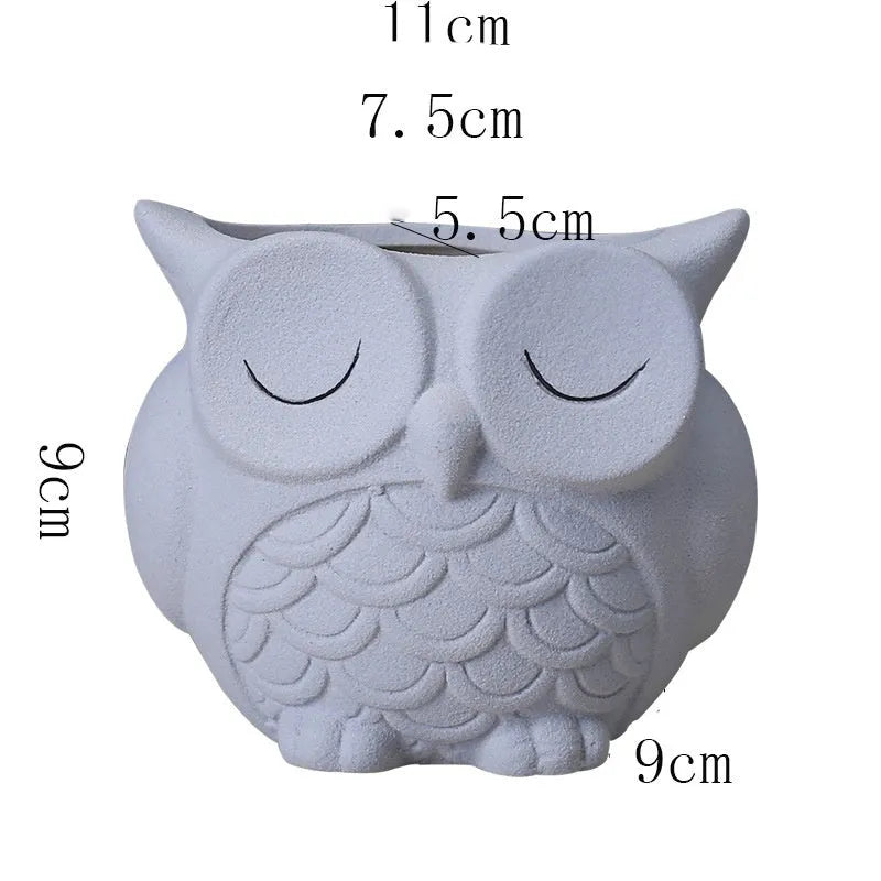 Handmade frosted ceramic owl planter for small succulents, shown in light pink.