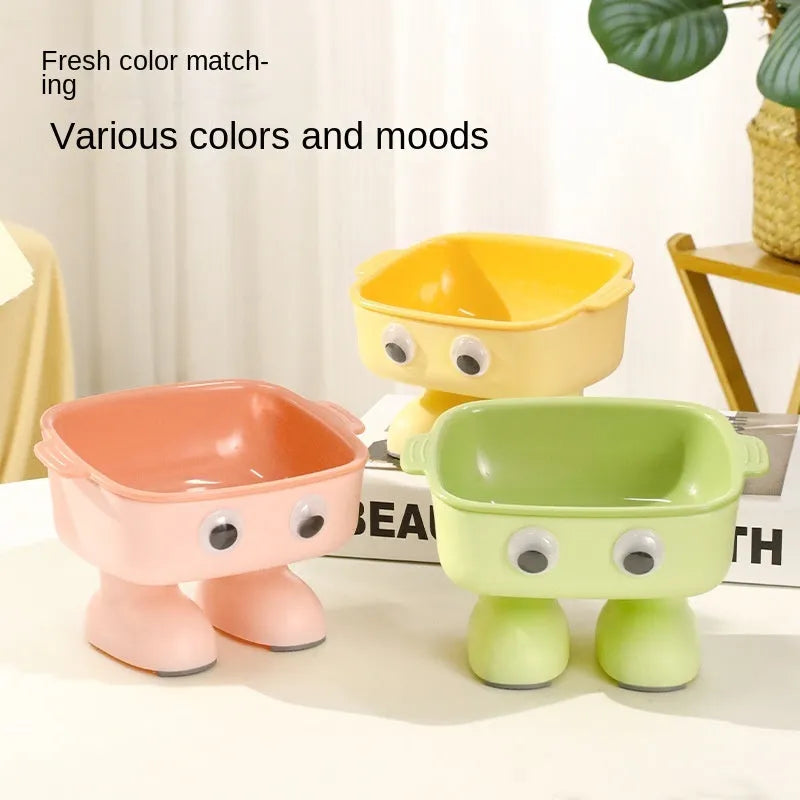 Robot-shaped elevated cat bowl with tilted feeding surface in green colour