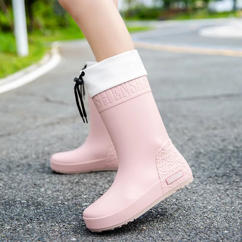 Women's solid-colour PVC rain boots with non-slip sole in apricot, black, brown, and pink