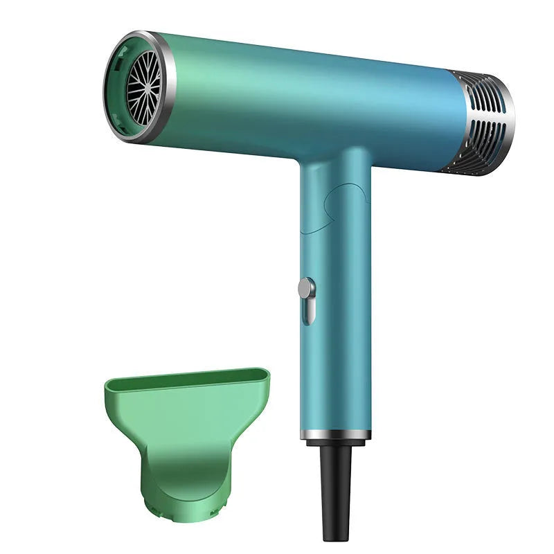 Green and purple foldable hair dryer with collapsed handle next to a suitcase, showing its compact travel size.