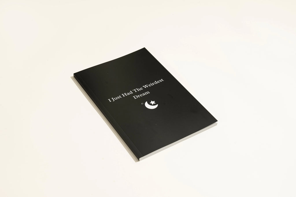 Black A5 hardcover dream journal notebook with elastic closure band.