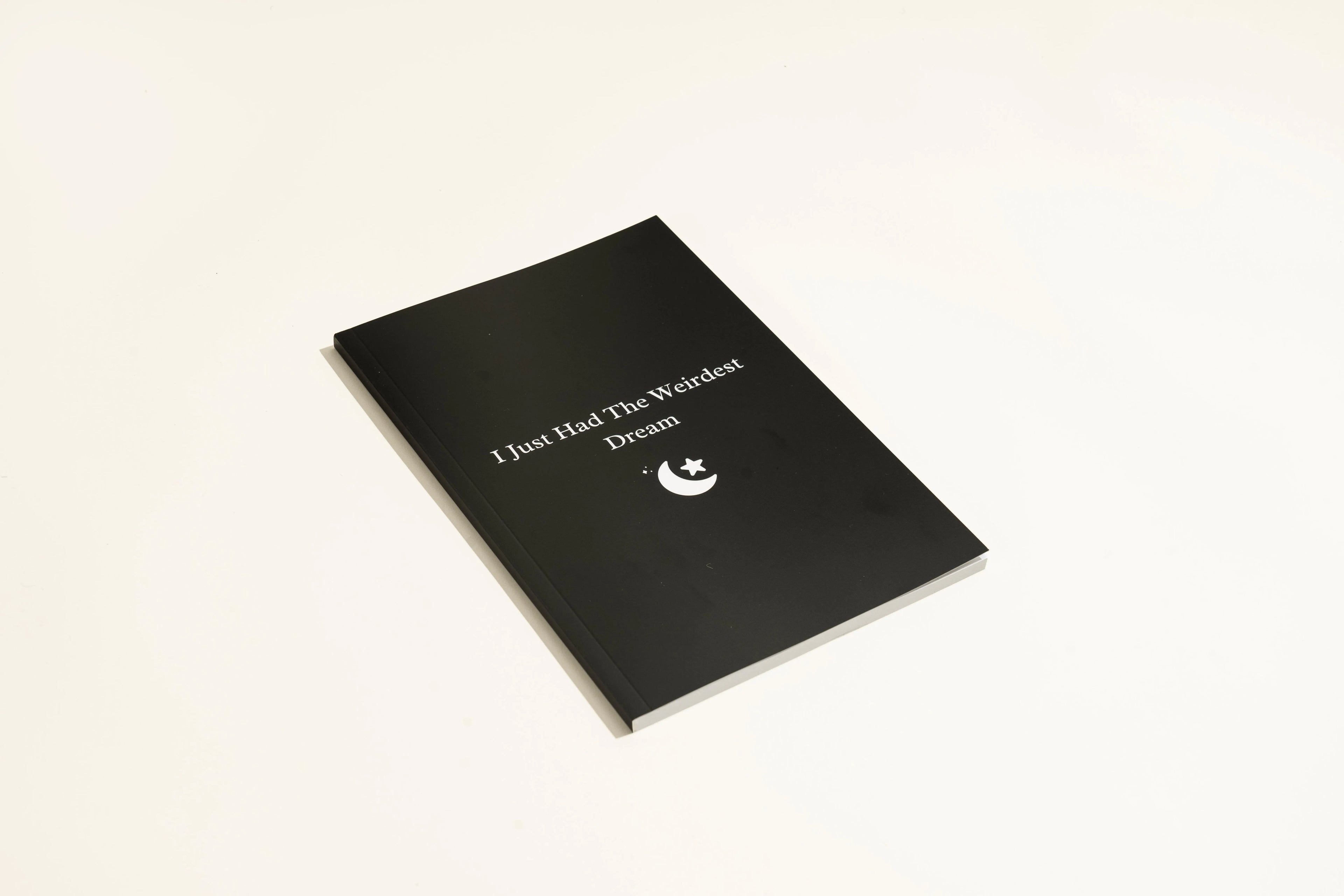 Black A5 hardcover dream journal notebook with elastic closure band.