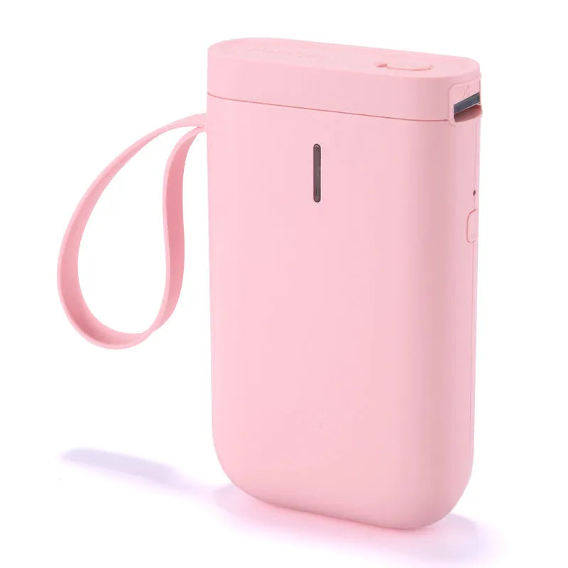 D11 compact white Bluetooth thermal label printer with USB cable and roll of label paper on a desk.