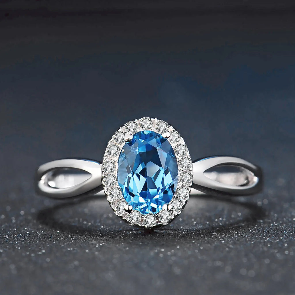 925 sterling silver jewellery set with blue topaz gems in geometric design including earrings, ring, necklace and pendant
