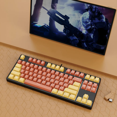 87 key wired mechanical keyboard with metal chassis shown in a black, orange, and yellow colour configuration.