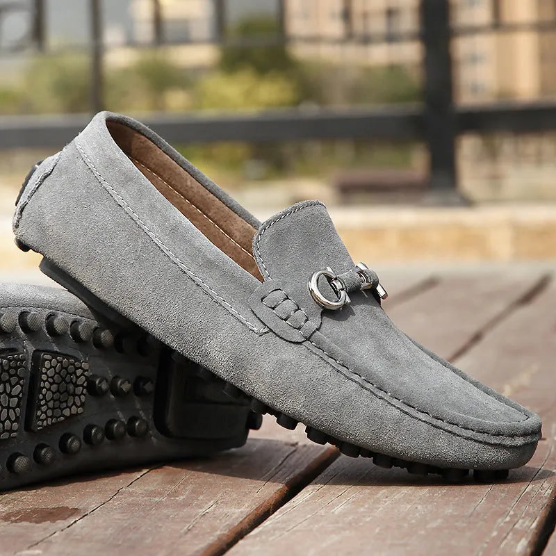 Men's black matte cowhide leather slip-on loafers with a square toe and flat rubber sole.
