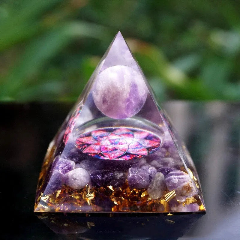 A small 6cm clear resin pyramid decoration with natural crystal gravel inside, on a neutral background.
