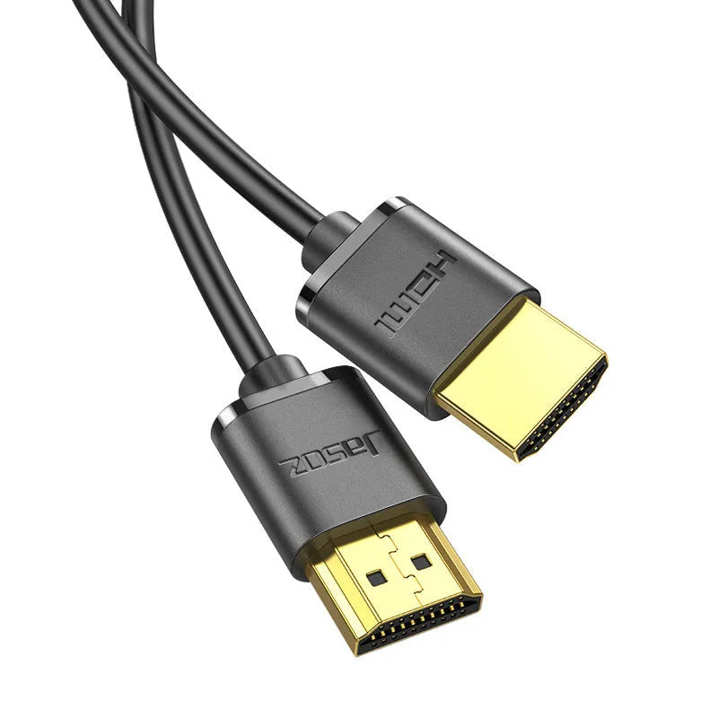 A thin, flexible HDMI cable with gold-plated connectors on a white background.