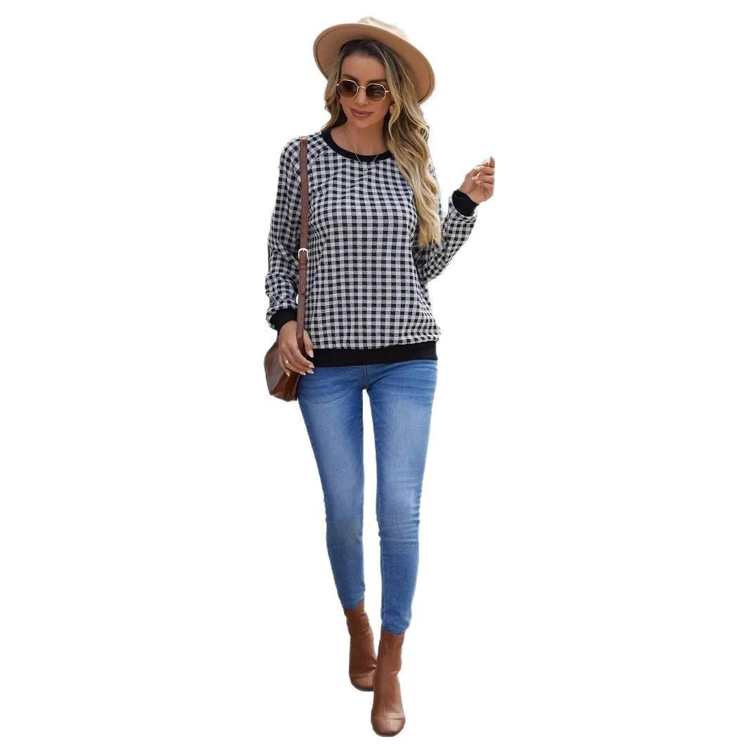 Black polyester pullover sweater with a plaid printed pattern and long sleeves.