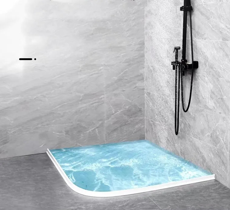 Flexible TPE bathroom water blocking strip in black on white tile floor