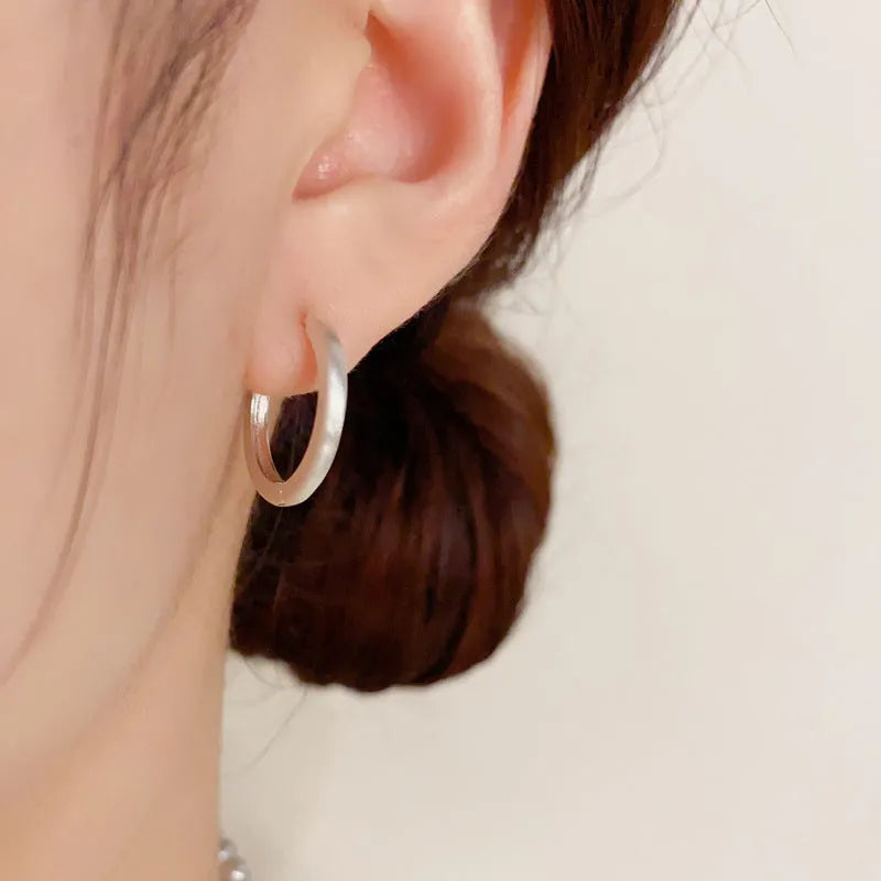 Geometric women's ear clip with real gold plating in gold colour showing round eyelet design
