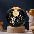 Starry sky luminous crystal ball on a round wooden base, illuminated with soft LED light.
