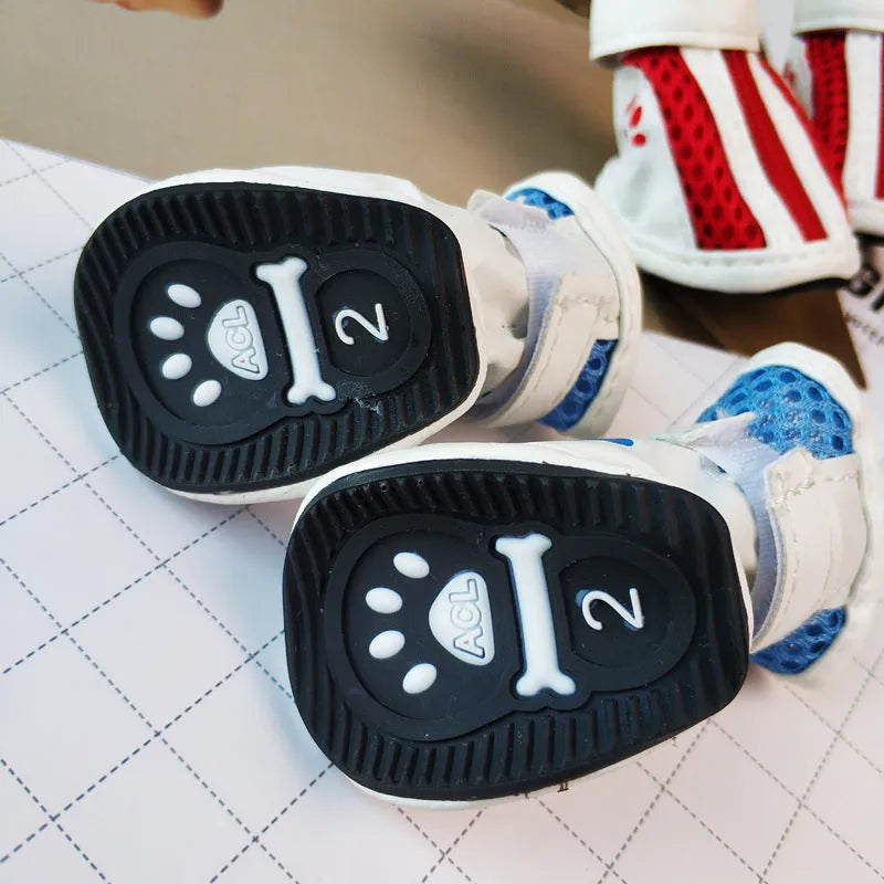 Set of four blue zipper closure cloth dog shoes with non-slip soles for small pets.