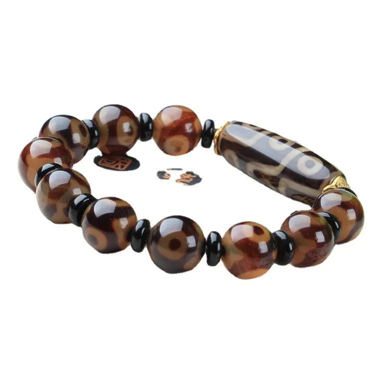 Distressed agate Tibetan beads bracelet featuring Three-eye Dzi and polished agate beads.
