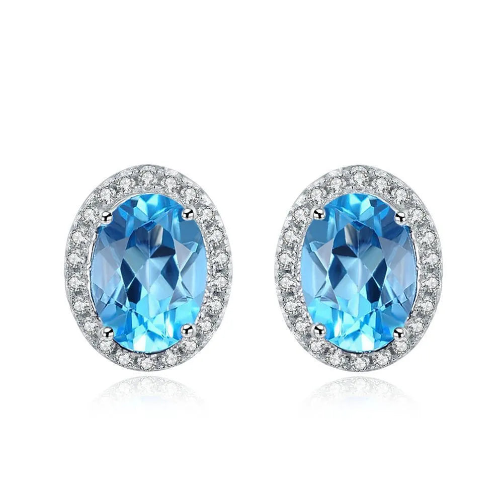 925 sterling silver jewellery set with blue topaz gems in geometric design including earrings, ring, necklace and pendant