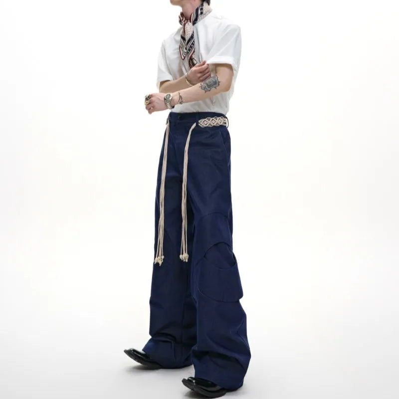Men's dark blue loose fit straight-leg jeans with decorative belt stitching and zipper details.