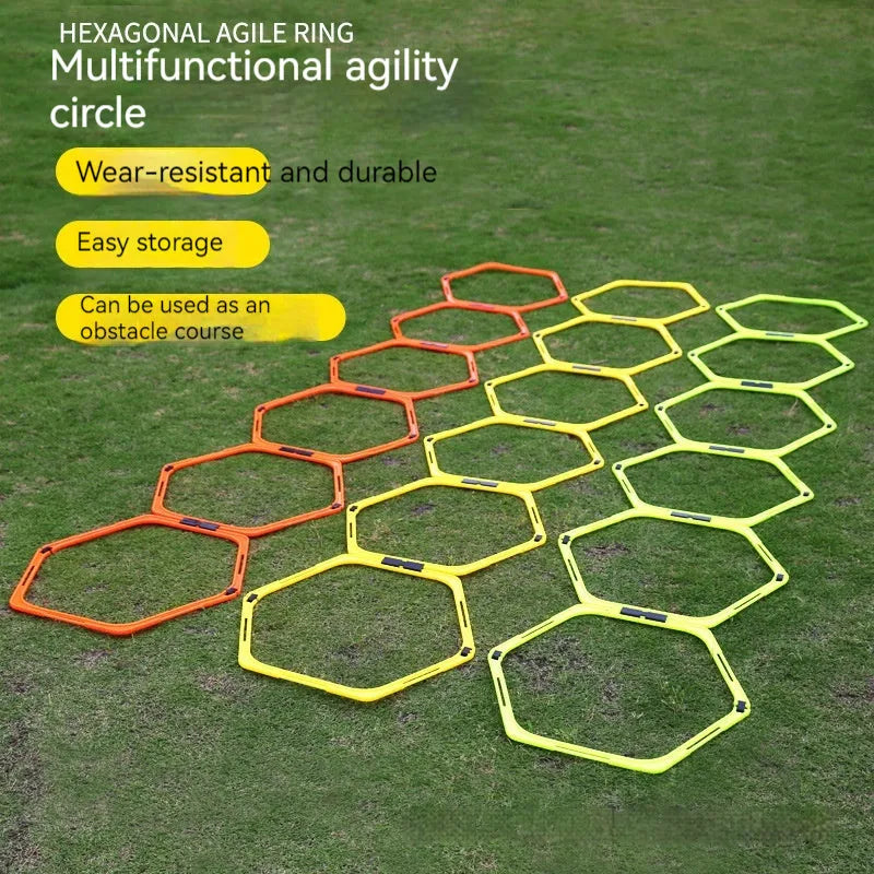 Six foldable hexagon football agility training rings in yellow, green, and orange colours laid out on grass.