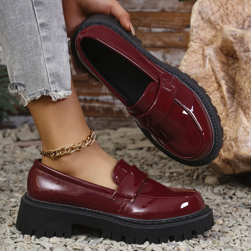 Women's black chunky heel slip-on loafers with a platform rubber sole.