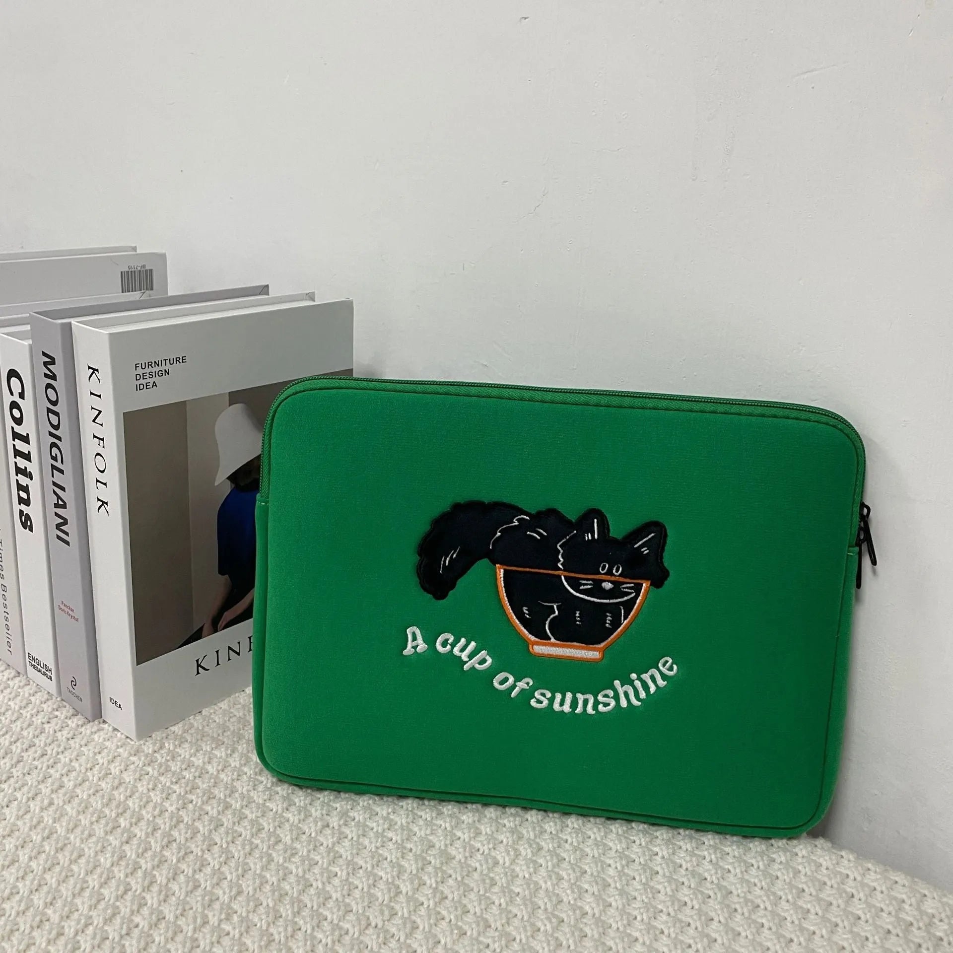 Embroidered laptop sleeve with animal design showing polyester construction and laptop size compatibility