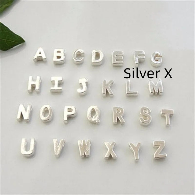 Gold and silver alloy peach heart shaped letter pendant necklace charm on a chain.