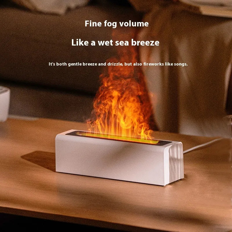 Black square USB aroma diffuser humidifier with colour-changing flame LED light and water tank on a wooden table.