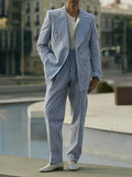 Blue and white striped polyester suit set with blazer and trousers on a hanger.