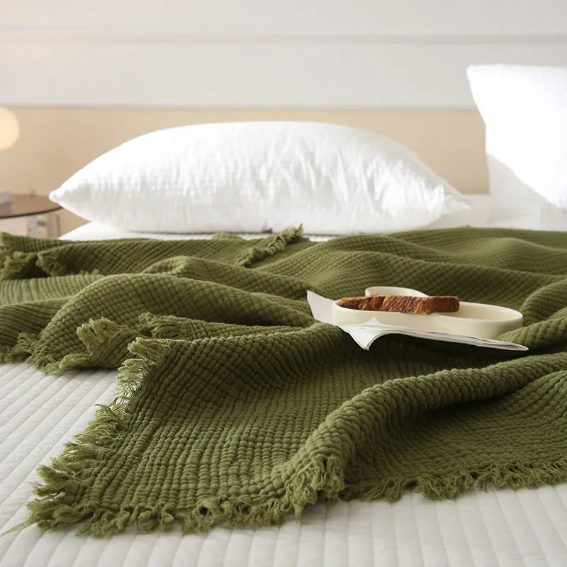 Four-layer cotton gauze blanket with tassel trim in avocado green colour