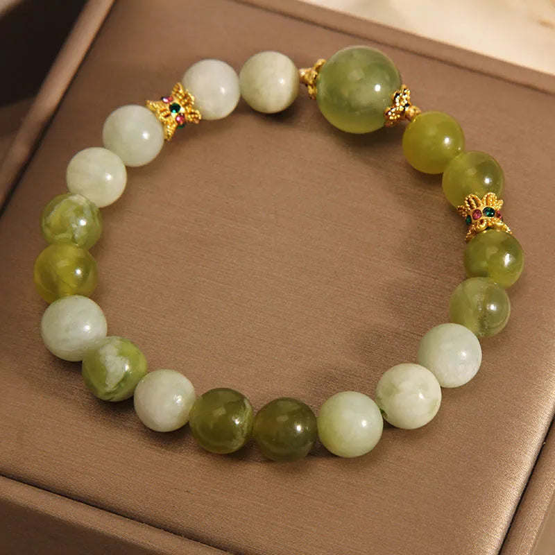 Xiuyan jade green women's bracelet with original design on a wrist.