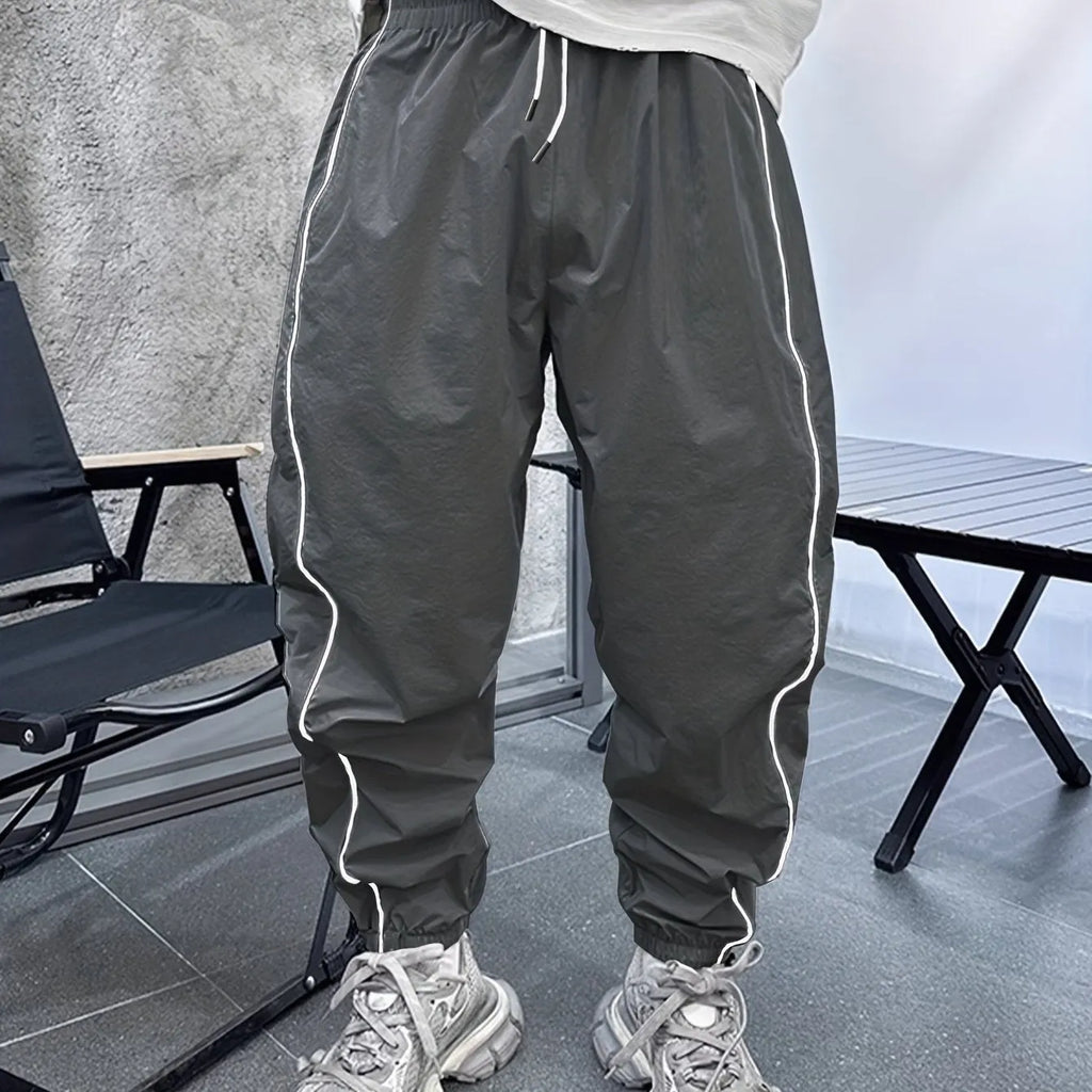 Men's blue bamboo fibre sports trousers with a loose, cropped fit and elastic waist.
