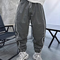 Men's blue bamboo fibre sports trousers with a loose, cropped fit and elastic waist.
