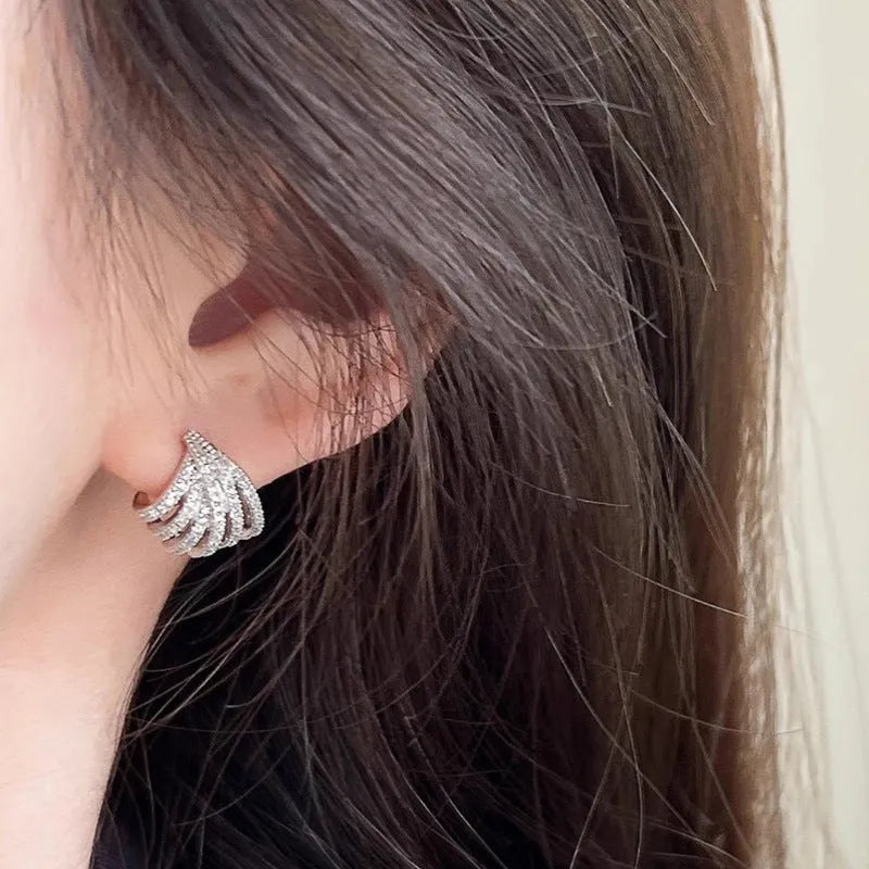 Pair of geometric line design earrings with platinum electroplated finish on zircon.