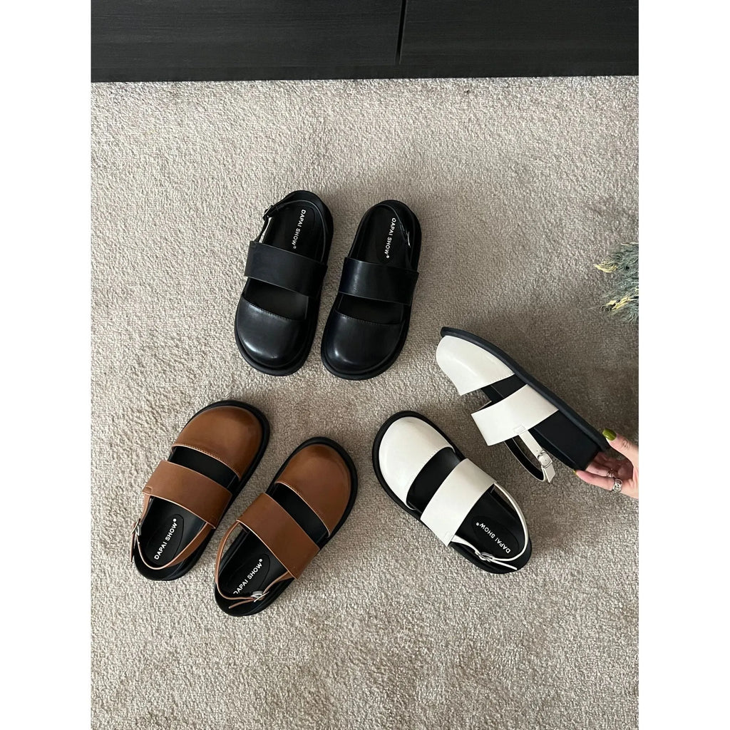 Retro brown platform sandals with a single ankle strap buckle and closed round toe.