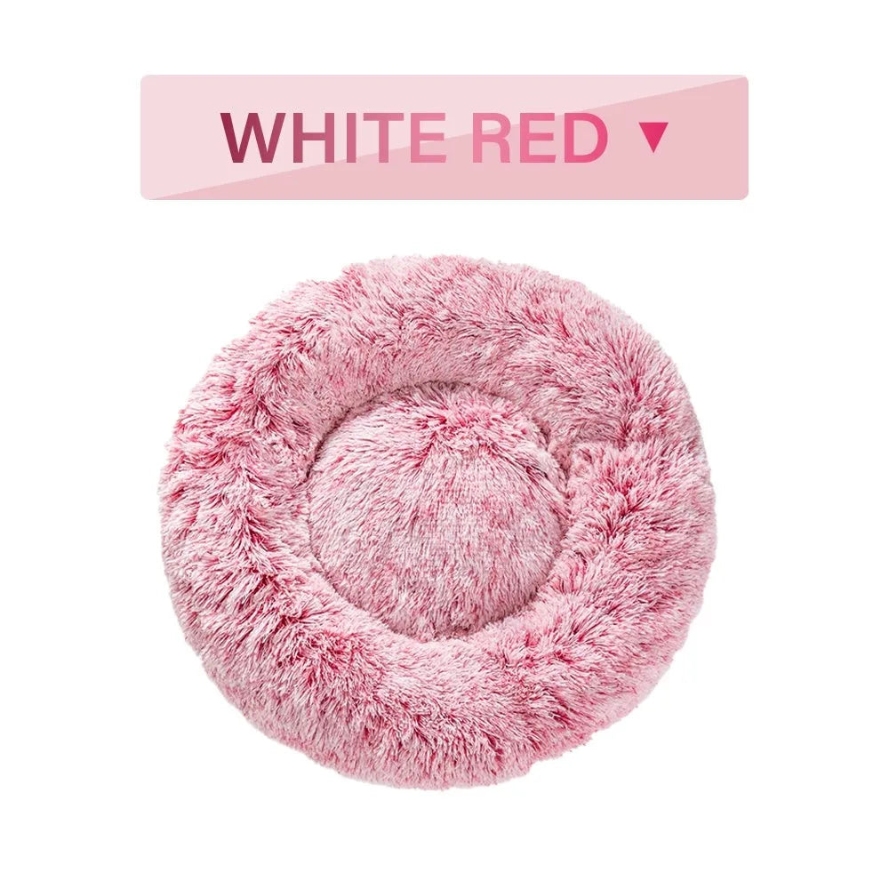A round donut-shaped dog bed with a raised plush rim, shown in a light grey colour.