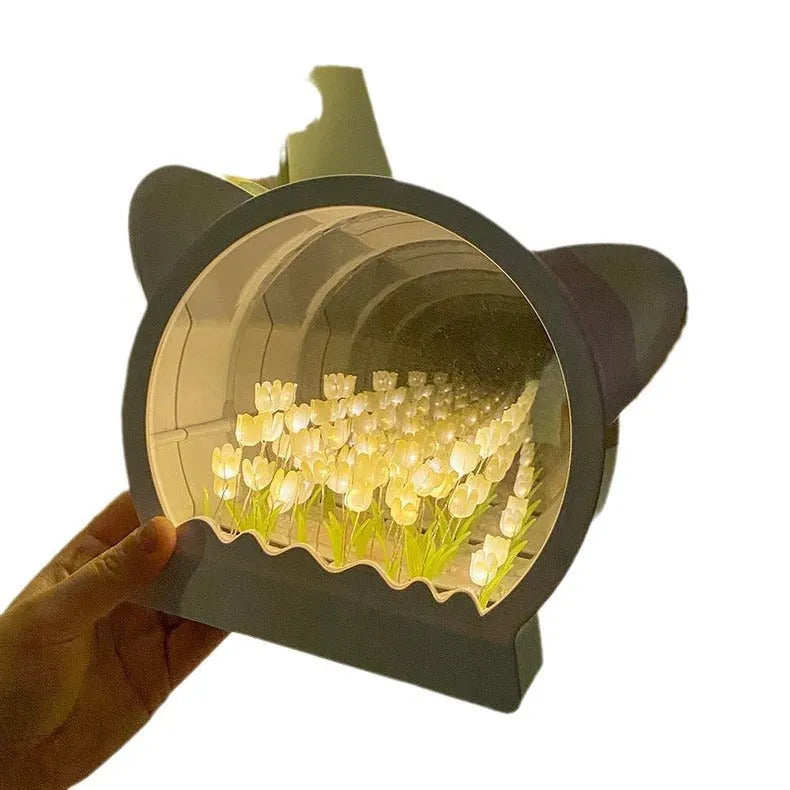 Handmade DIY cat head silhouette night lamp surrounded by tulip flowers, shown in pink colour option.