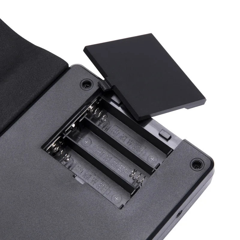 49-key portable folding electronic keyboard in gloss black, showing folded and unfolded positions