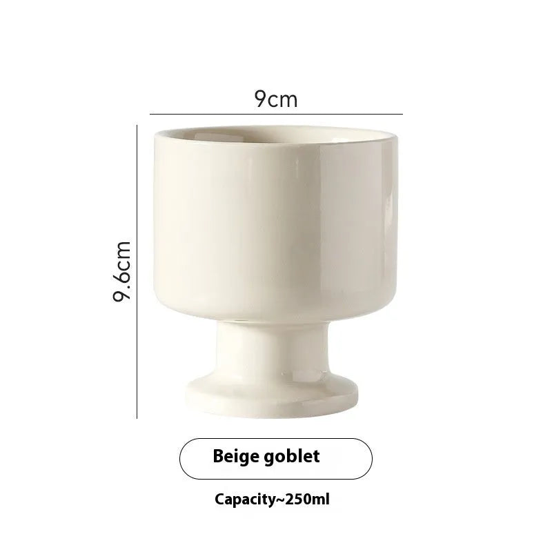 Hand-pinched irregular ceramic mug in a solid colour, shown from the side to display its unique shape.