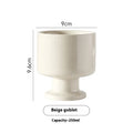 Hand-pinched irregular ceramic mug in a solid colour, shown from the side to display its unique shape.