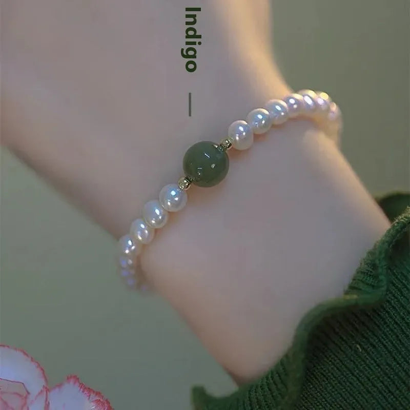 Chinese style handmade glass bead bracelet with bamboo joint elements on a white background.