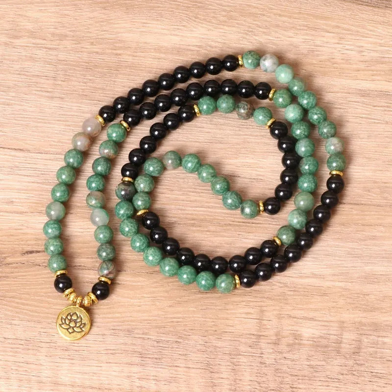 Green and black alloy beaded bracelet with elastic closure showing natural style design