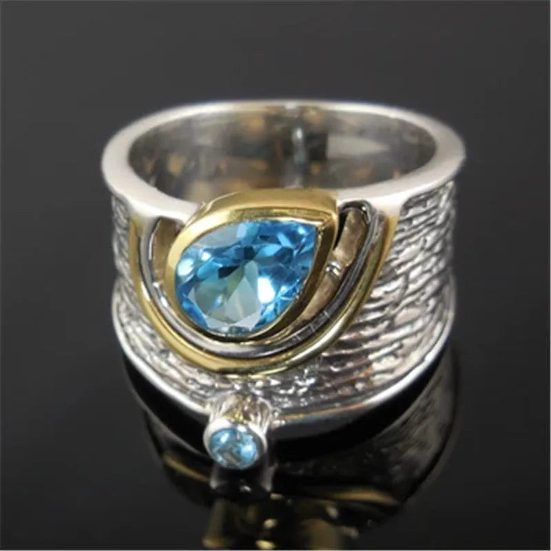 Blue zircon rhinestone ring in Chinese style with drop shape design on woman's hand