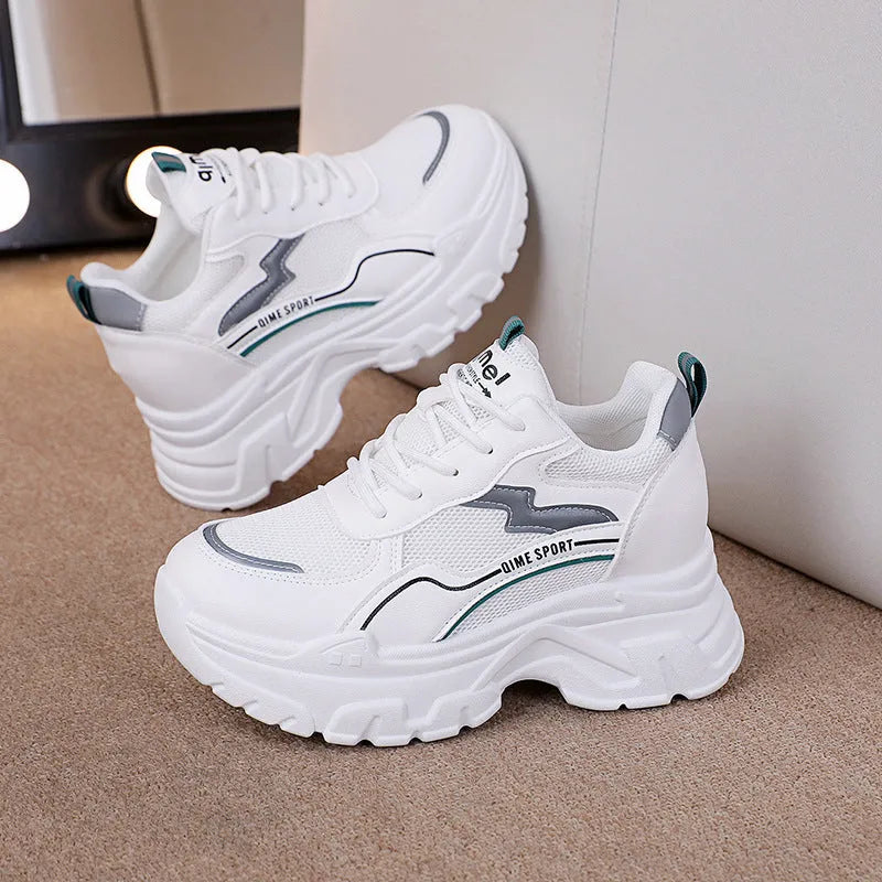 Women's white and beige dad shoes with cross shoulder straps and lace-up front, showing round toe.
