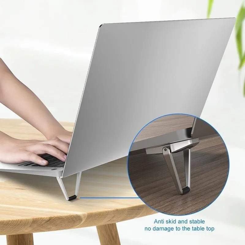 Portable aluminium alloy folding laptop bracket in silver and white colours with 3M adhesive backing