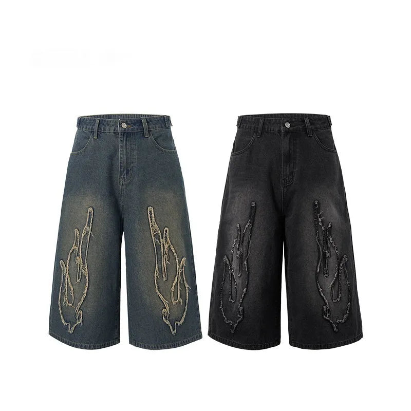 Men's black denim shorts with flame embroidery patch and cropped length for summer streetwear