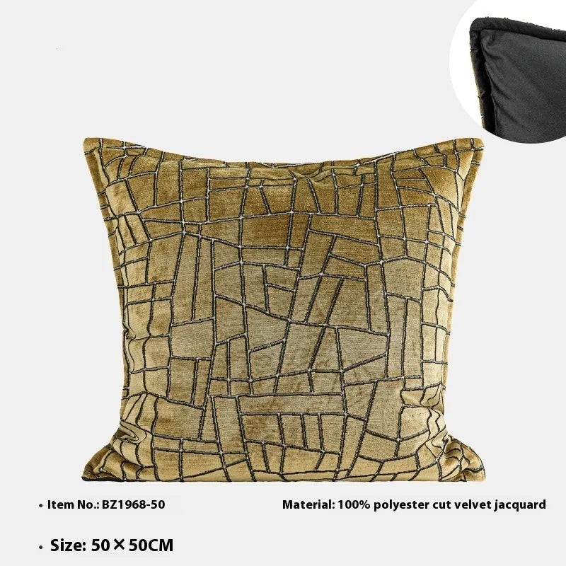 Geometric abstract patterned cushion in local gold colour, shown in square and lumbar sizes on a grey sofa.