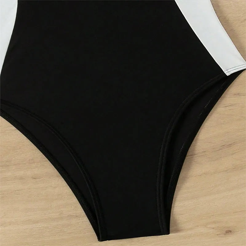 Black and white women's sleeveless one-piece swimsuit with slim fit and spaghetti straps